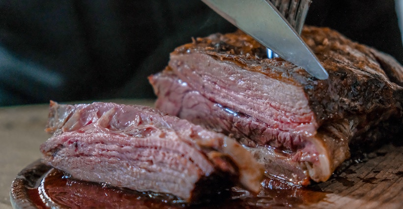 Steak knife slicing through meat