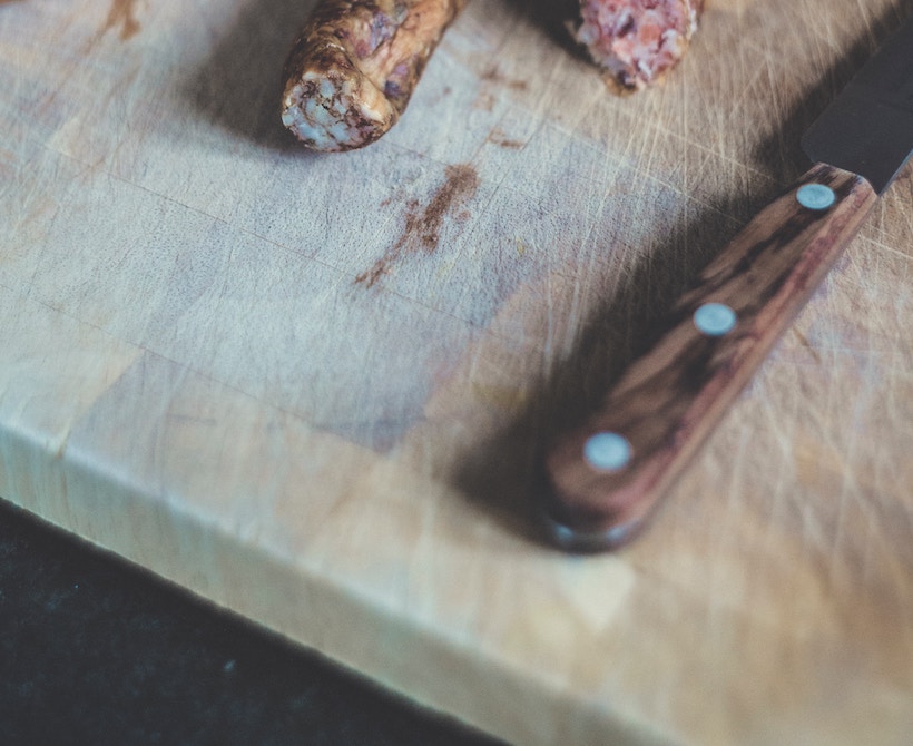 Untreated end grain cutting board with knife