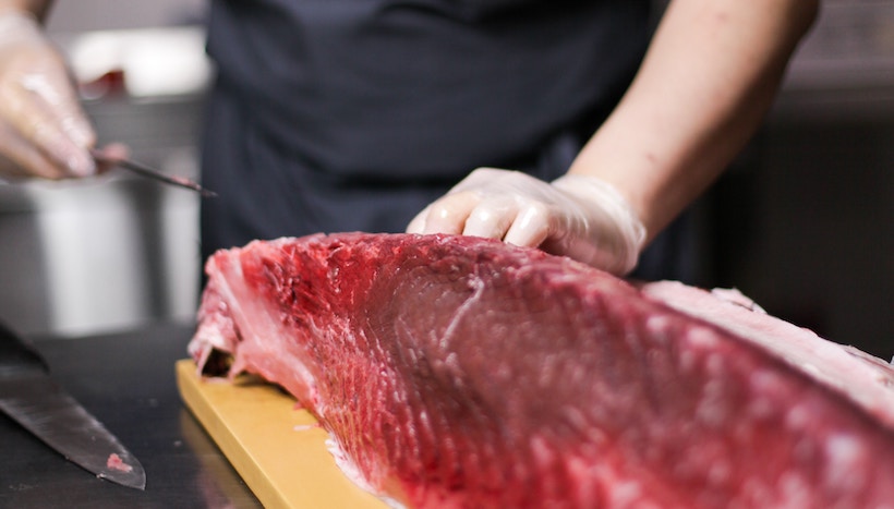 Man slicing a fresh fish