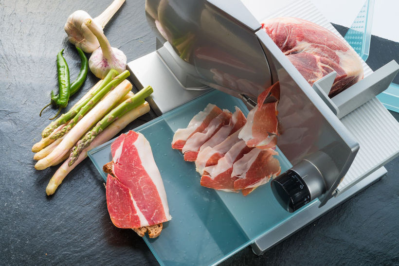 Meat slicing machine making prosciutto