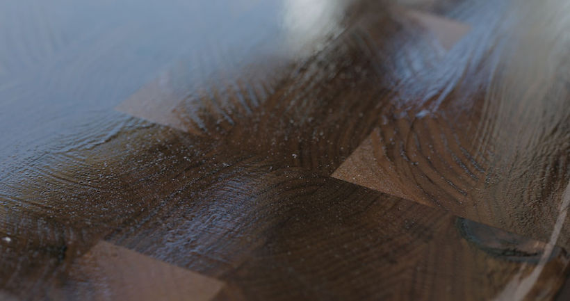 woodworker applying oil finish to walnut end grain wood board