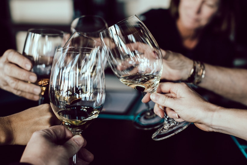 Group toasting with white wine