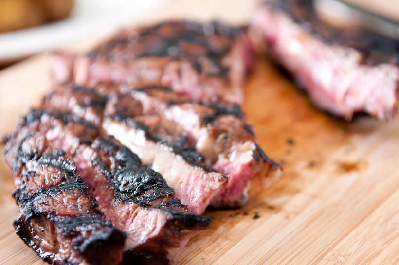 Cooked red meat cut on a cutting board