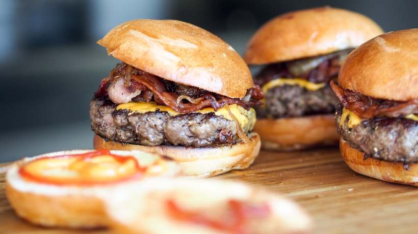 Four bacon cheeseburgers with perfectly placed buns