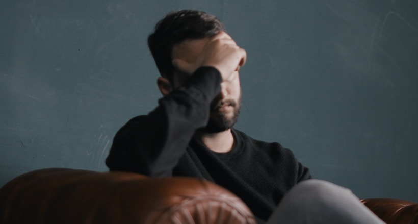 Man with a headache in a leather chair