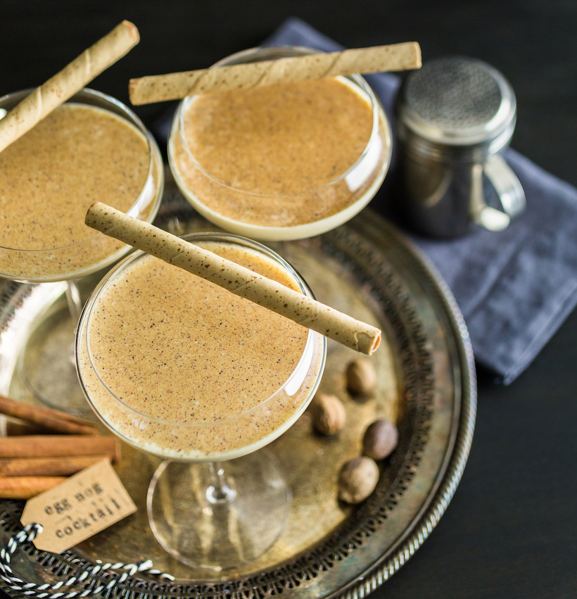 Tray of eggnog cocktails with cinnamon sticks