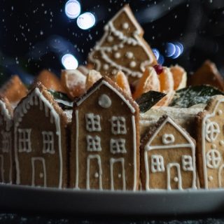 Gingerbread village with tree centerpiece and lights in back