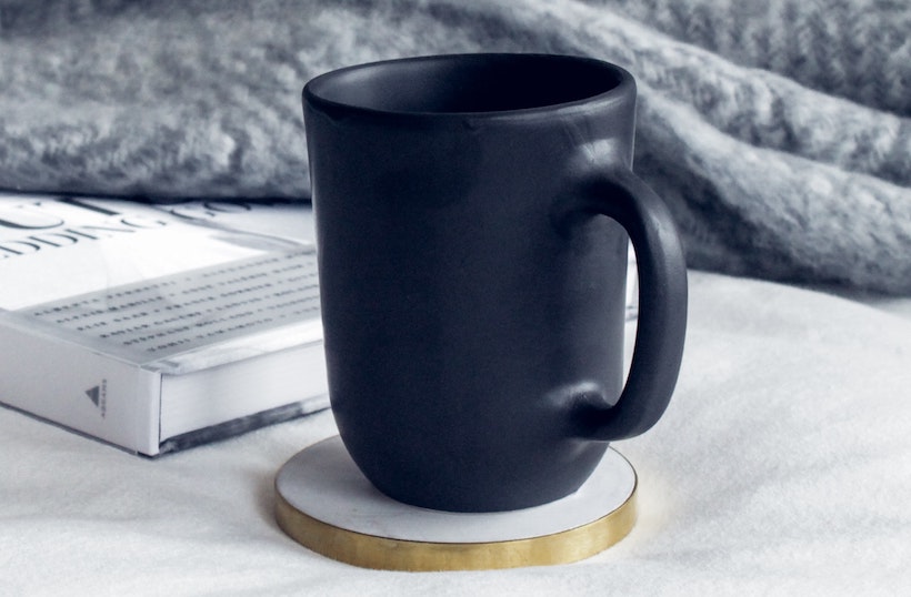 Ceramic mug next to a book