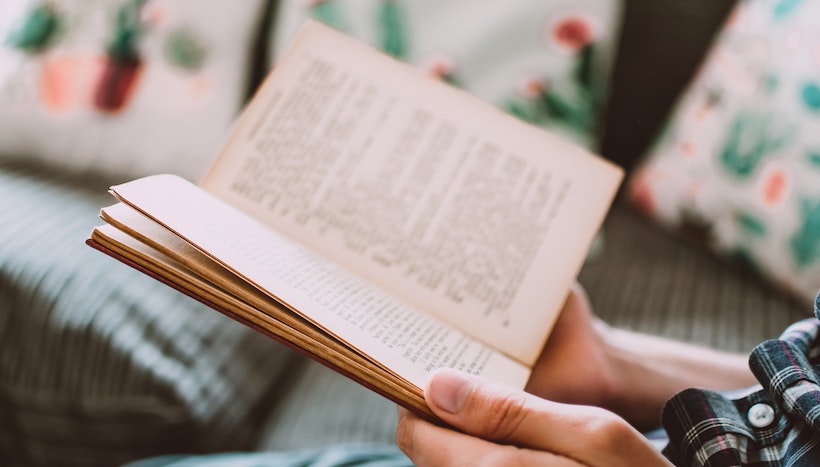 Person reading an old book