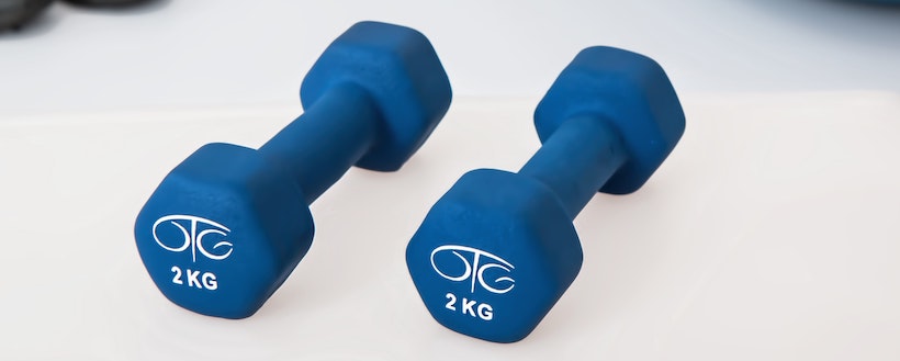 Small blue dumbbells on a white floor