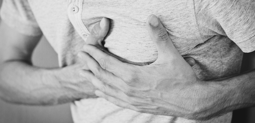 Black and white man holding stomach in pain