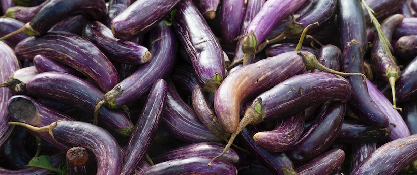 A large bunch of purple eggplants