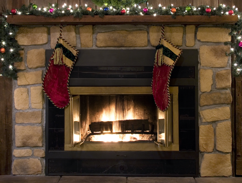 Two Christmas stockings hanging by the fireplace.