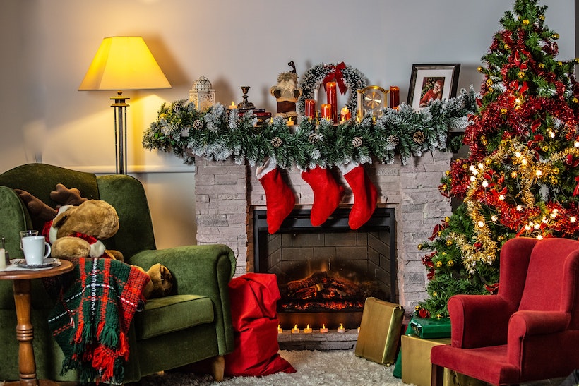 Decorated room with Christmas decorations and a lit fireplace