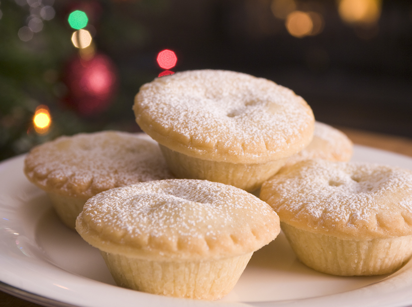 Plate of mince pies in front of fire and Christmas Tree