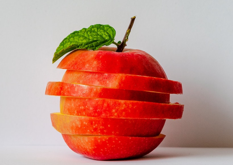 An apple in slices stacked to look like a whole