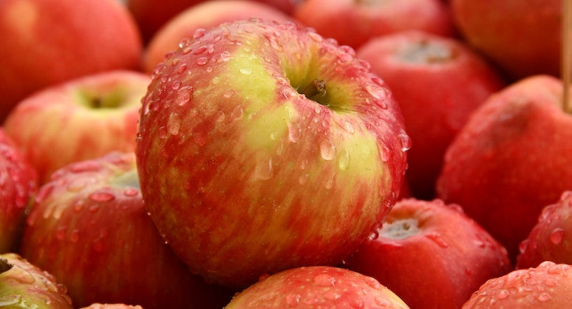 Wet apple in a bunch of apples