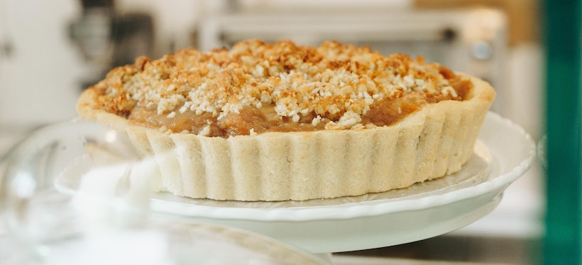 An apple crumble on white porcelain plate