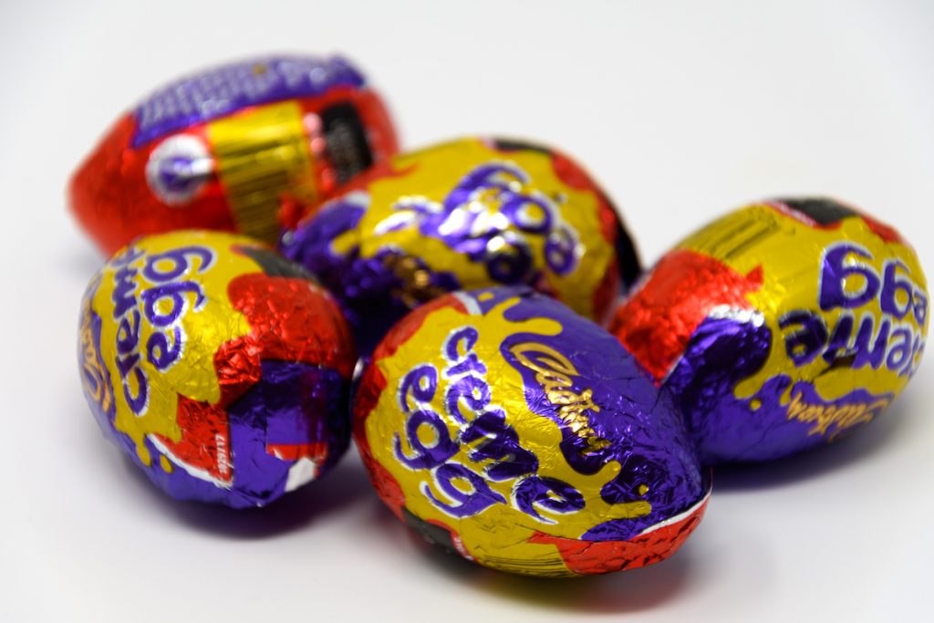 Reading, United Kingdom - April 19 2019: Five Cadbury's Creme Eggs in their foil wrappers