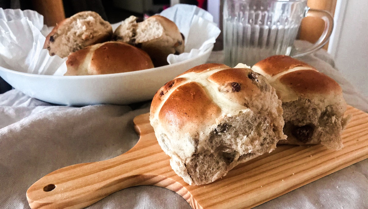 Hot cross buns on a cutting board