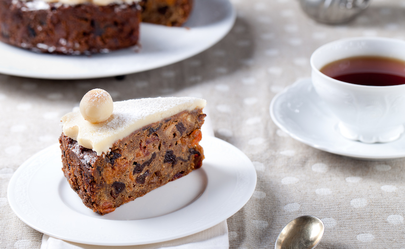 Traditional English Easter simnel cake with marzipan decoration on a white plate